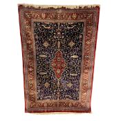 A signed Persian silk Qum rug with central lozenge medallion in a scrolling field over the