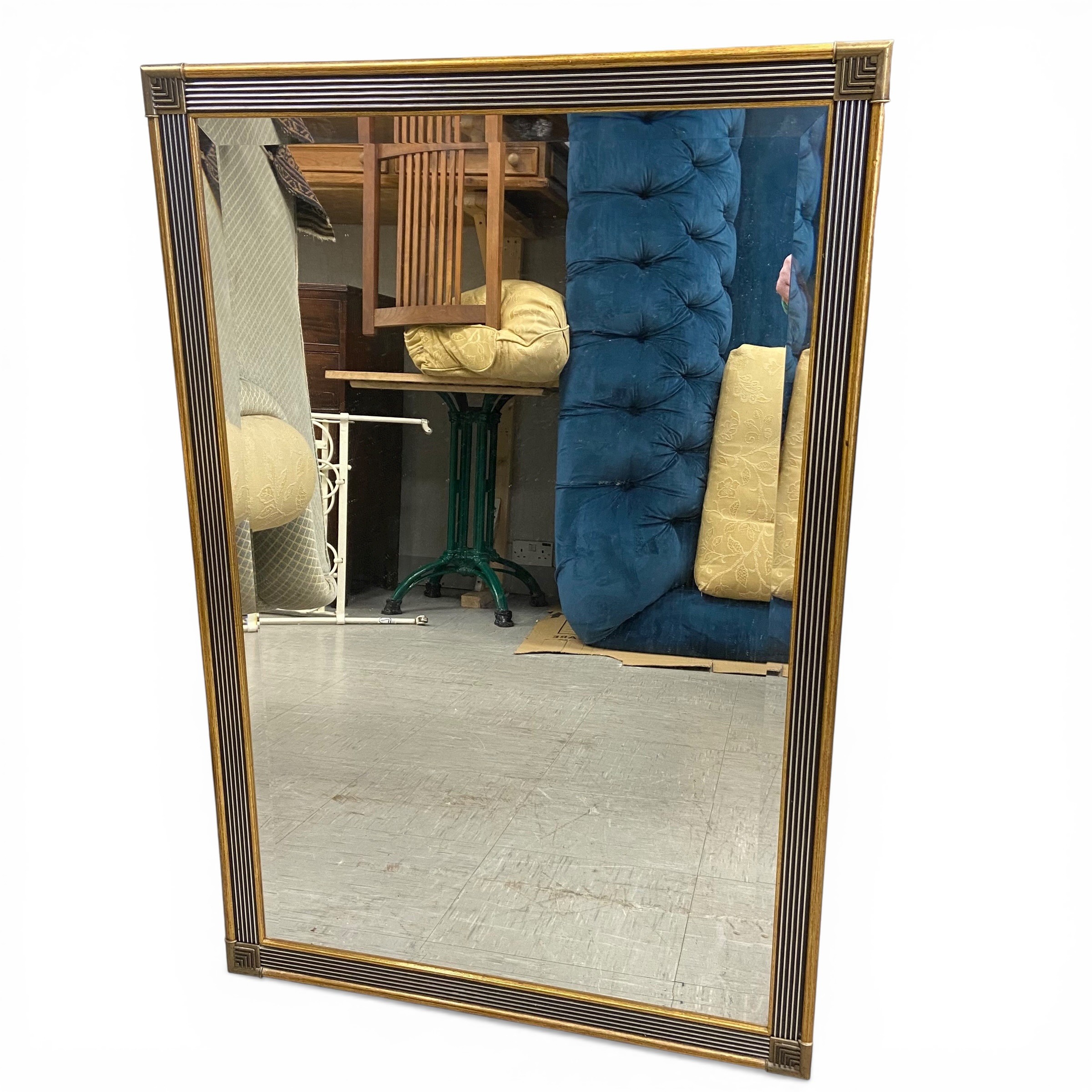 A contemporary Art Deco style wall mirror with bevelled plate in a reeded gilt frame. 94x63cm.