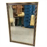 A contemporary Art Deco style wall mirror with bevelled plate in a reeded gilt frame. 94x63cm.