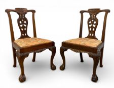 A pair of mid Georgian style teak side chairs each with shaped openwork splat over the needlework