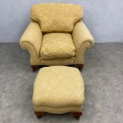 A contemporary armchair upholstered in piped foliate damask and the matching footstool. H.78 W.105