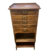 An Edwardian walnut sheet music cabinet with square galleried top over five fall front drawers and