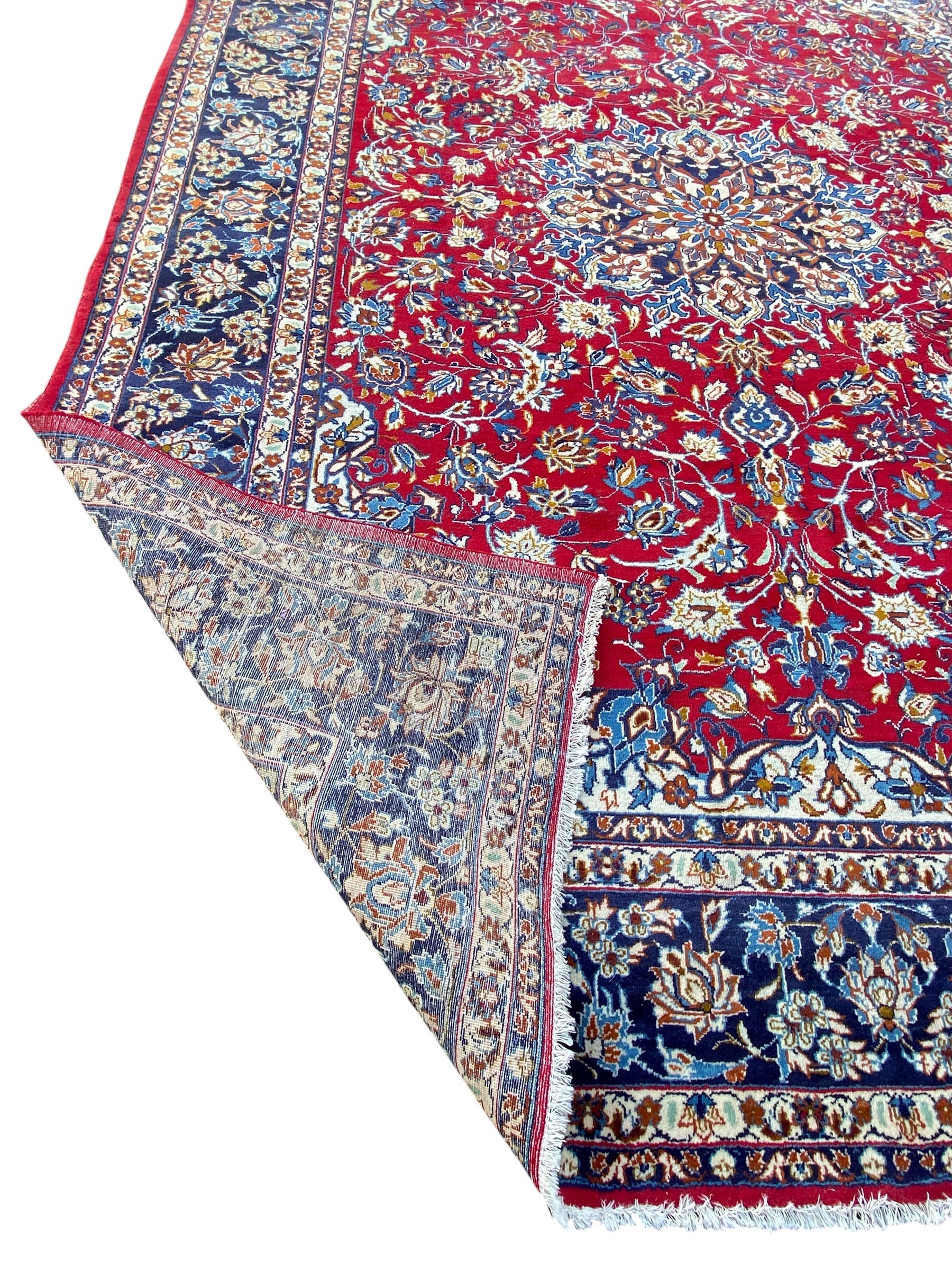 A large Persian Najafabad carpet with central flowerhead medallion in the polychrome field over a - Image 4 of 4