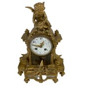 A 19th century French gilt metal mantle clock with figural putti cresting over the convex