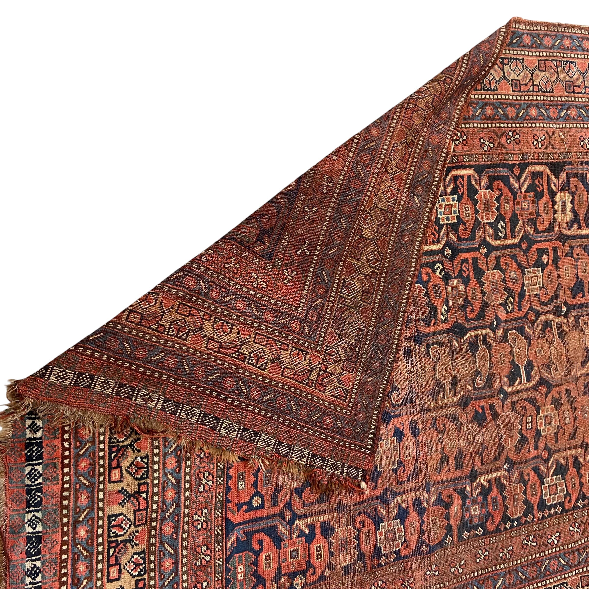 A large Persian Baluch carpet with five rows of sixteen polychrome guls over a midnight blue - Image 5 of 5