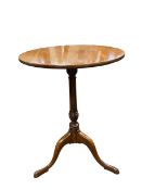 A 19th century mahogany lamp table with circular top over the turned pedestal raised on swept tripod