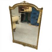A vintage wall mirror with shaped plate in a 19th century style brass frame. 98x62cm.