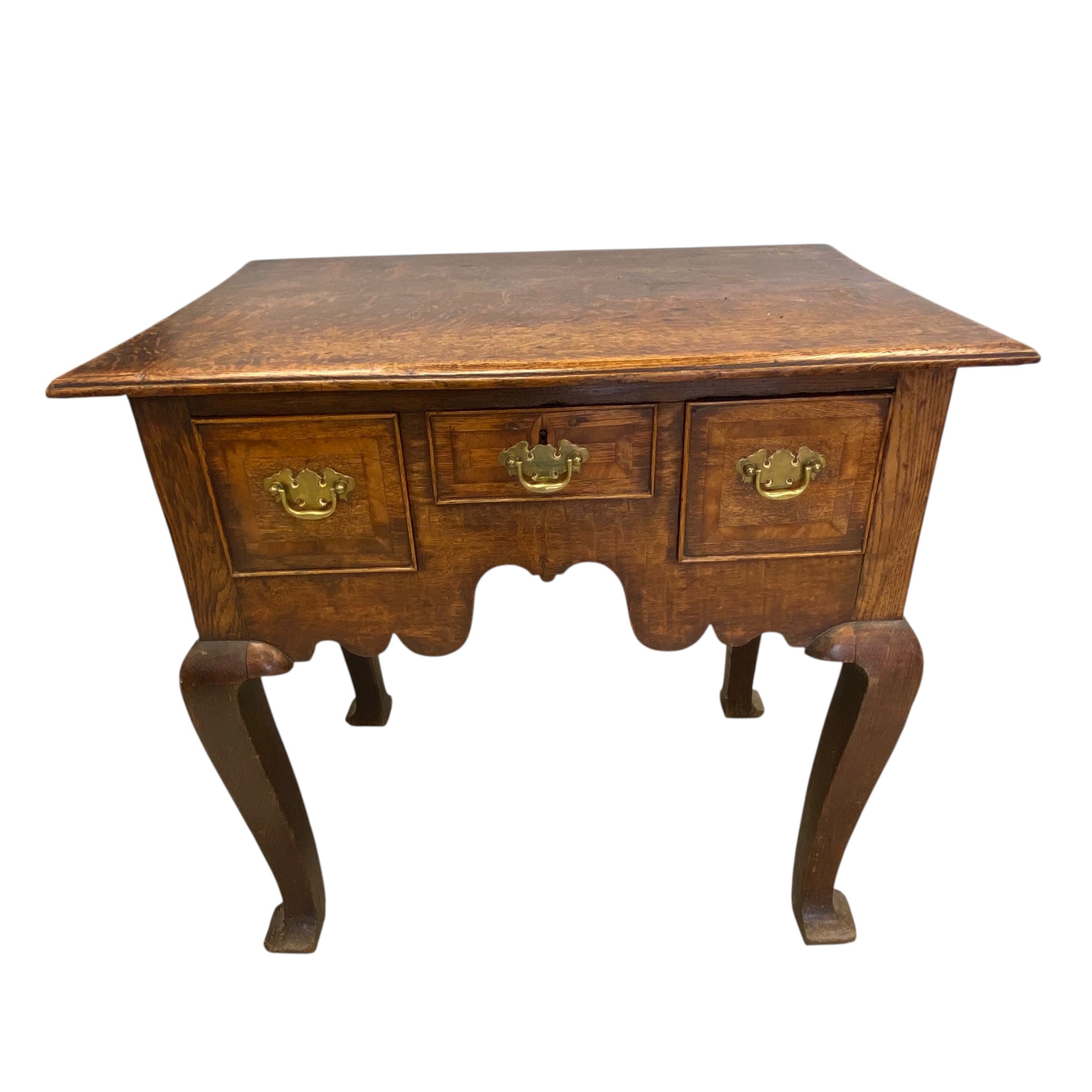 A Georgian oak lowboy with plank top over three frieze drawers raised on square section cabriole