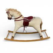 A small vintage rocking horse in corduroy upholstery. H.76 W.110cm.