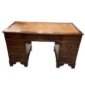 An mid 20th century Georgian style mahogany twin pedestal desk with gilt and tooled tan leather
