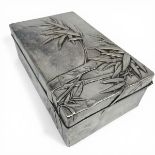 An early 20th century Japanese hammered sterling silver cigarette box with bamboo decoration and