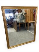 A large contemporary gilt-framed wall mirror. 153x127cm.