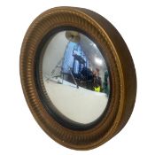 A vintage Regency style wall mirror with circular convex plate in a moulded gilt plaster frame.