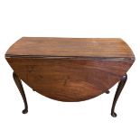 A Georgian mahogany drop leaf dining table with circular figured top raised on cabriole supports