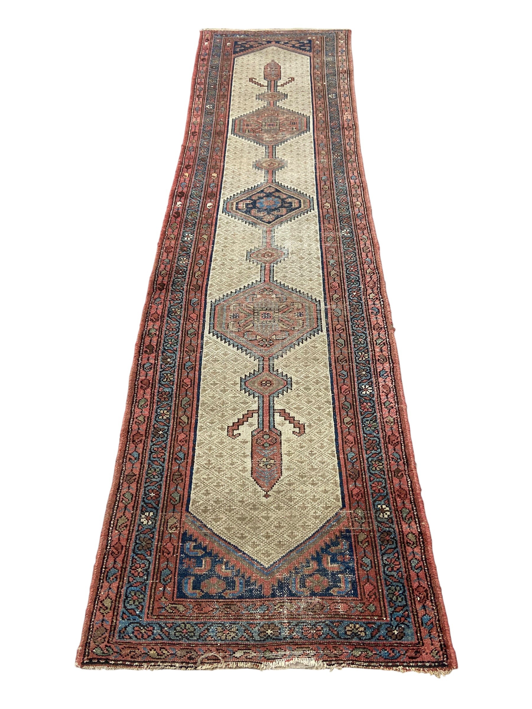A Persian Sarab runner with central stepped pole medallion in a repeating geometric field over an
