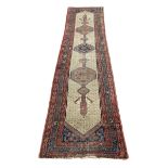 A Persian Sarab runner with central stepped pole medallion in a repeating geometric field over an