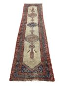 A Persian Sarab runner with central stepped pole medallion in a repeating geometric field over an
