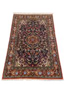 A Persian Kashan rug with central flowerhead medallion and scrolling polychrome field over the
