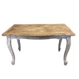 A vintage French farmhouse style coffee table with quatrefoil parquetry top raised on carved,