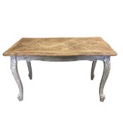 A vintage French farmhouse style coffee table with quatrefoil parquetry top raised on carved,