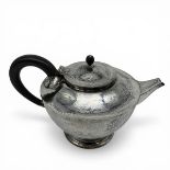 An Arts & Crafts hammered sterling silver teapot by Birmingham Guild of Handicraft Ltd, 1901 with