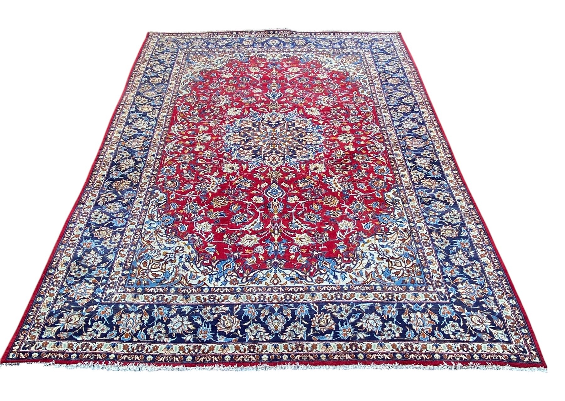 A large Persian Najafabad carpet with central flowerhead medallion in the polychrome field over a