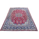 A large Persian Najafabad carpet with central flowerhead medallion in the polychrome field over a