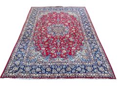 A large Persian Najafabad carpet with central flowerhead medallion in the polychrome field over a