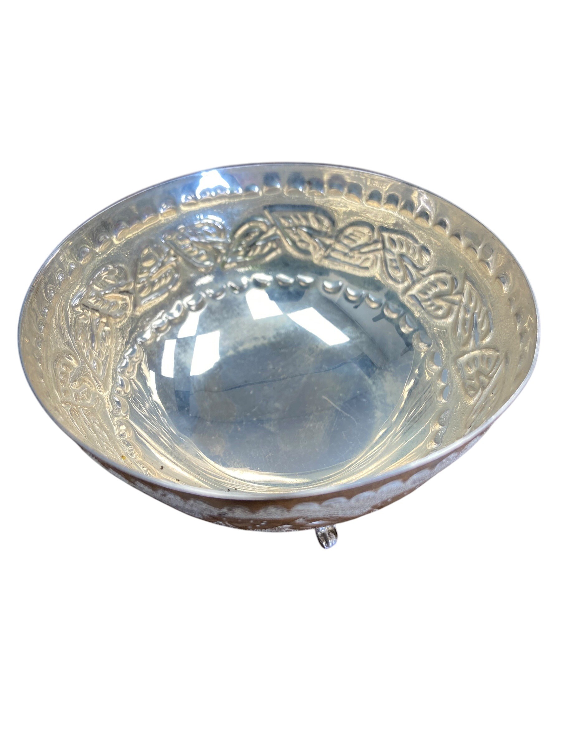 A Continental 830 marked white metal bon-bon dish with chased leaf decoration raised on three pad