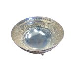 A Continental 830 marked white metal bon-bon dish with chased leaf decoration raised on three pad