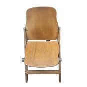 A 1940s American Seating Co. campaign style folding chair with shaped, bent ply back and seat raised
