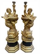 A pair of large and impressive full height carved and giltwood figure group candelabras each with