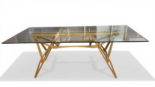 A contemporary Italian Reale dining table with rectangular plate glass top raised on a skeletal
