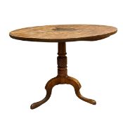 A 19th century mahogany occasional table with circular tilt-top over the carved pedestal raised on