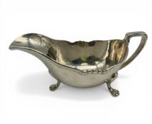 A 1930s hallmarked sterling silver gravy boat by Harrods Ltd, Sheffield, 1939. H.7 W.18cm. Weight: