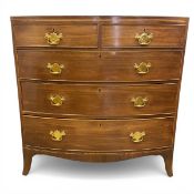 A Georgian mahogany bow-fronted chest of two short over three long cockbeaded drawers raised on