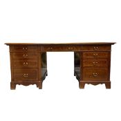 A 19th century mahogany twin pedestal desk with gilt and tooled tan leather top over an