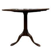 A Georgian mahogany tripod table with circular tilt top over the turned pedestal raised on splayed