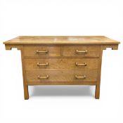 An Arts & Crafts oak sideboard or chest of two short over three long drawers raised on straight
