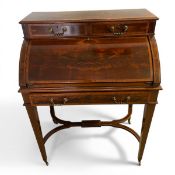 An Edwardian mahogany cylinder desk with crossbanded superstructure fitted with drawers over the