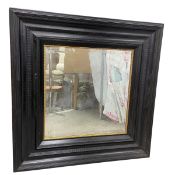 A large 19th century Dutch wall mirror with original bevelled plate in a heavy ripple-moulded and