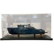 A contemporary model of a Bluegame luxury yacht in a perspex display case raised on a square