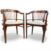 A pair of C.1900 mahogany tub armchairs with shaped and spindled backs over the needlework