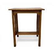 A C.1900 Arts & Crafts oak side or occasional table with plank top and openwork sides raised on