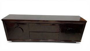 A contemporary lacquered zebrawood sideboard with an arrangement of cabinets and drawers raised on a
