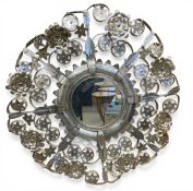 A vintage wall mirror with circular plate in a pressed and applied floral sheet metal frame. Diam.