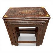A nest of four vintage Eastern style hardwood tables each with engraved and brass inlaid top