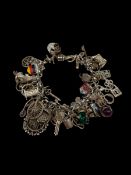 A vintage mixed hallmarked silver and white metal charm bracelet. Weight: 86g