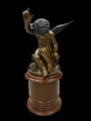 A large vintage bronzed spelter putto figure in the French 19th century style raised on a