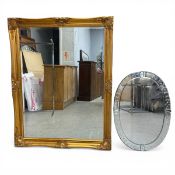 A contemporary gilt framed wall mirror together with a vintage etched and bevelled Venetian style